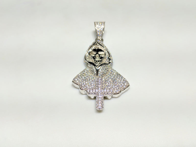 In the center: a white sterling silver hooded skeleton iced out with cubic zirconia in a beautiful micro pave setting made by Popular Jewelry in New York City